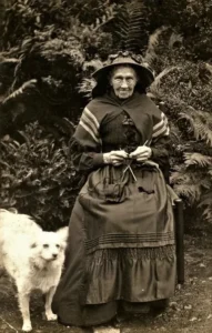 1900 Strickende Frau und ihr Spitz
